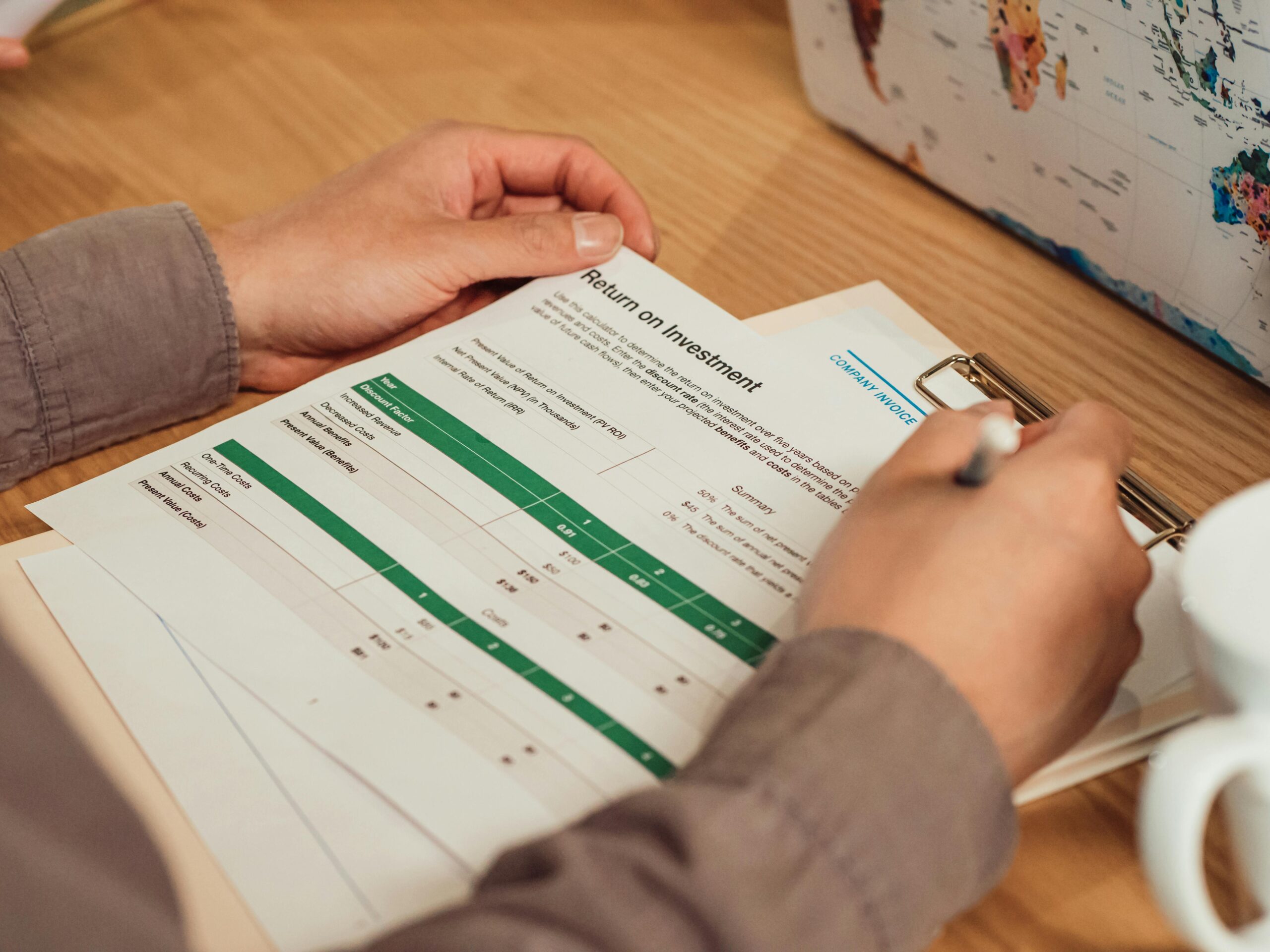 Person holding documents, symbolizing how a PIM system reduces manual paperwork and saves time through centralized product information and automated workflows.