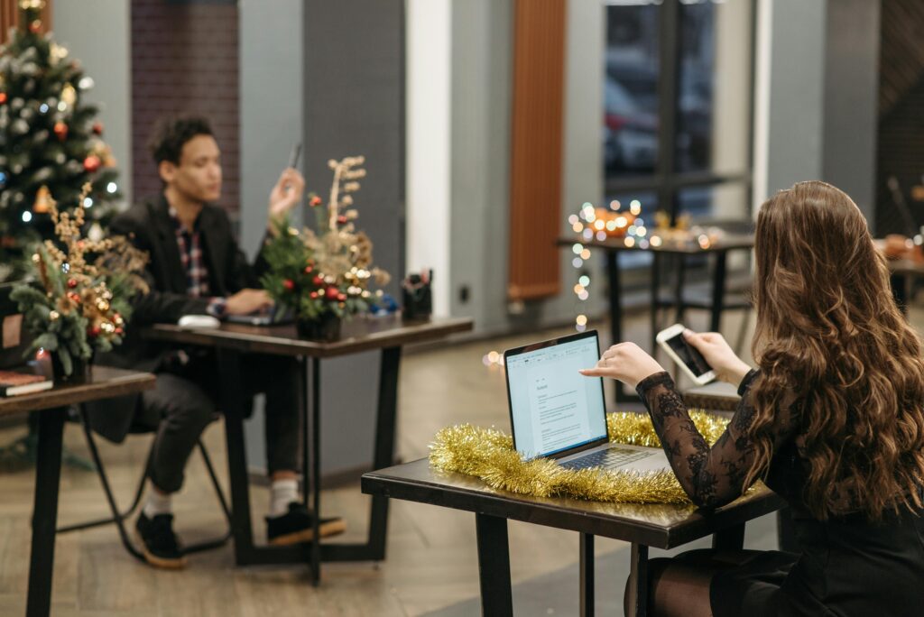 Two colleagues at work, one reflecting on progress over the year.